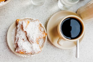 A coffee and a breakfast treat.