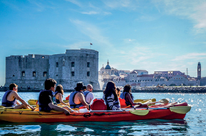 A group of Topdeck travelers kayaking down in Dubrovnik.