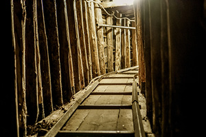 A set of tracks lead further into the barely lit War Tunnel, located in Sarajevo.