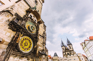 A view of the 600 year old astronomical clock with Prague castle in the background.