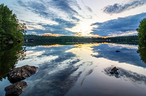 Midnight sun shining over Finnish lake.