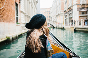 Topdeck traveler taking a gondola ride in Venice.