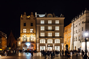 Buildings in Krakow's bar district lit up at night.