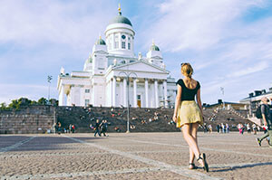 Topdeck traveler standing in front of Helsinki Cathedral.