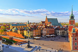 A view of Warsaw's Royal Castle, with the light of the evening sunset shining on it.