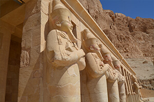 Statues of ancient pharaohs lined up in Egypt's Valley of the Kings. 