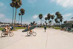 Cyclists riding through Venice Beach in Los Angeles.