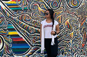 A Topdeck Traveler standing beside the famous graffiti adorned remnants of the Berlin Wall.