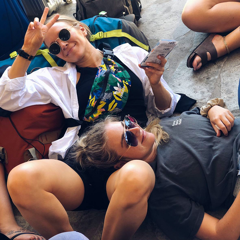 Topdeck Travelers lounging with their bags together on the floor.