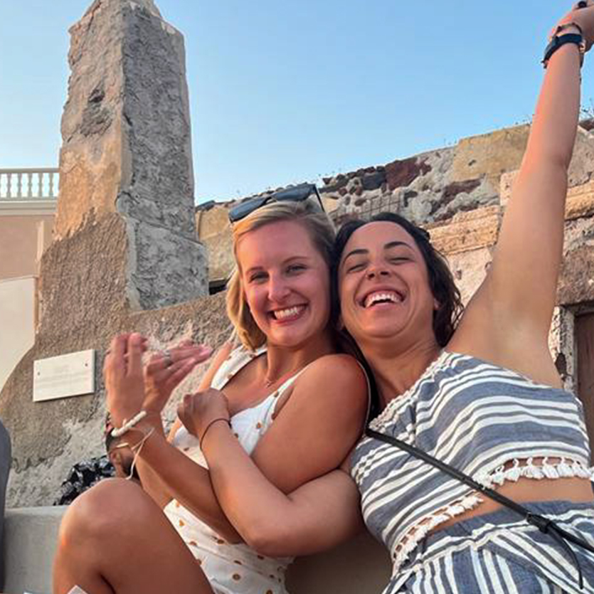 Topdeck travelers posing by an obelisk in an ancient ruin.