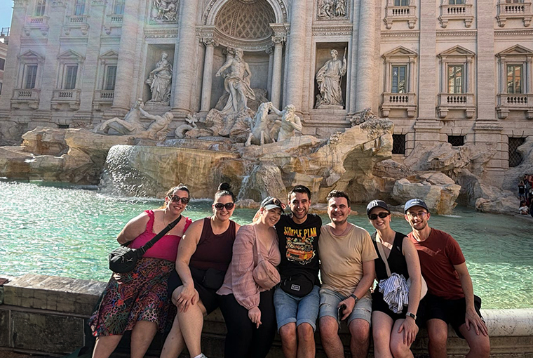 Topdeck travellers posing in front of the iconic Trevi Fountain in Rome..