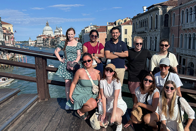 Topdeck travellers posing for a photo together in Venice.