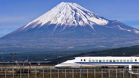 A view of a Japanese Bullet train passing in front of Mt Fuji