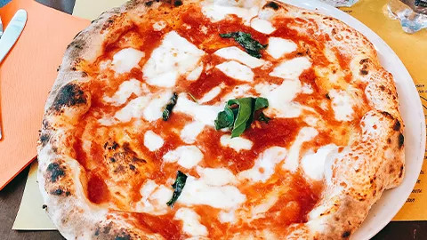Wood fire margherita pizza with fresh basil.