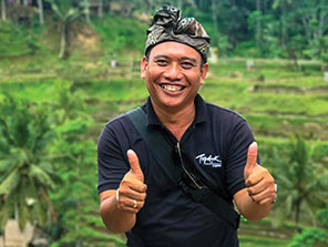 Topdeck Tour leader giving two thumbs up towards the camera during a tour through Asia.