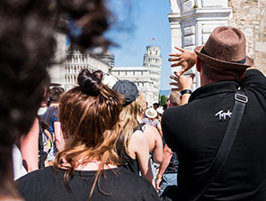 Topdeck Tour group taking photos of the famous Leaning Tower of Pisa.