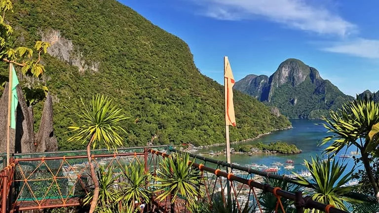 Balcony overlooking limestone cliffs and bright blue ocean.