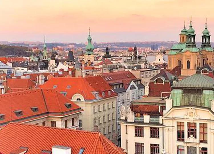 A woman looking out over the Cityscape of Prague.