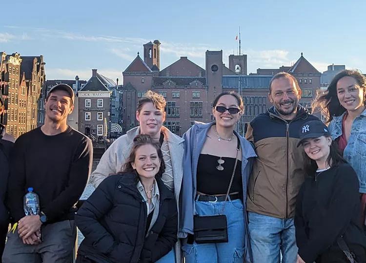 A group of Topdeck travellers posing for a photo together in Amsterdam.