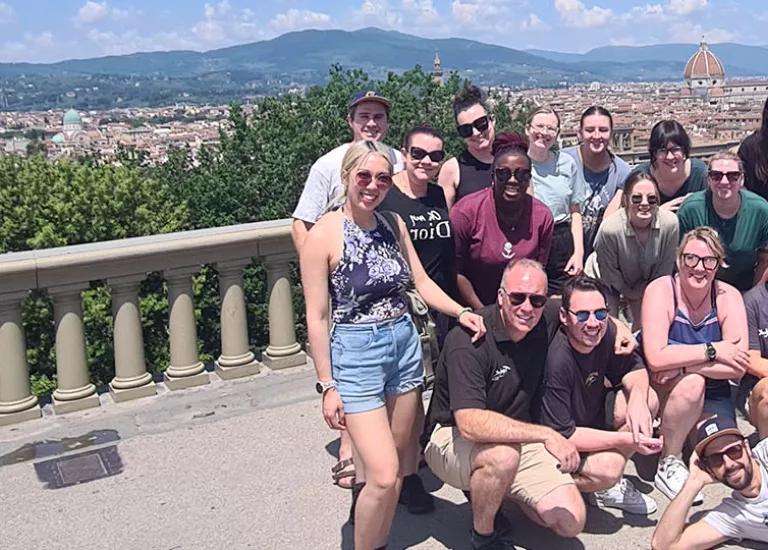 Topdeck Tour group during a Get Social trip through Italy posing for photo with the City of Florence in the background.