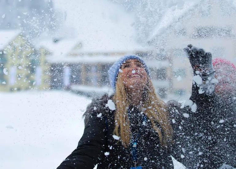 Two Topdeck travellers throwing around snow during a Topdeck Winter trip.