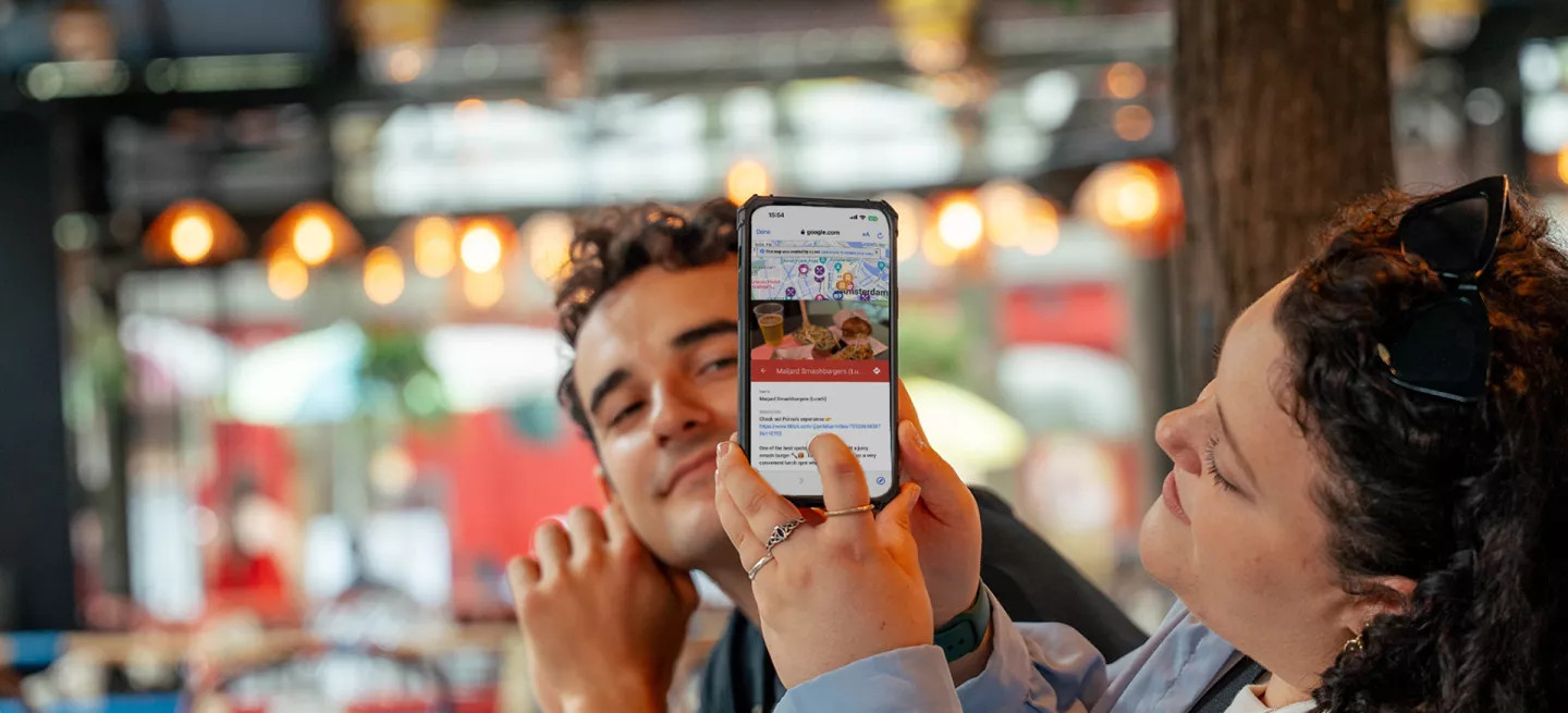 A person showing the Topdeck app on their phone.