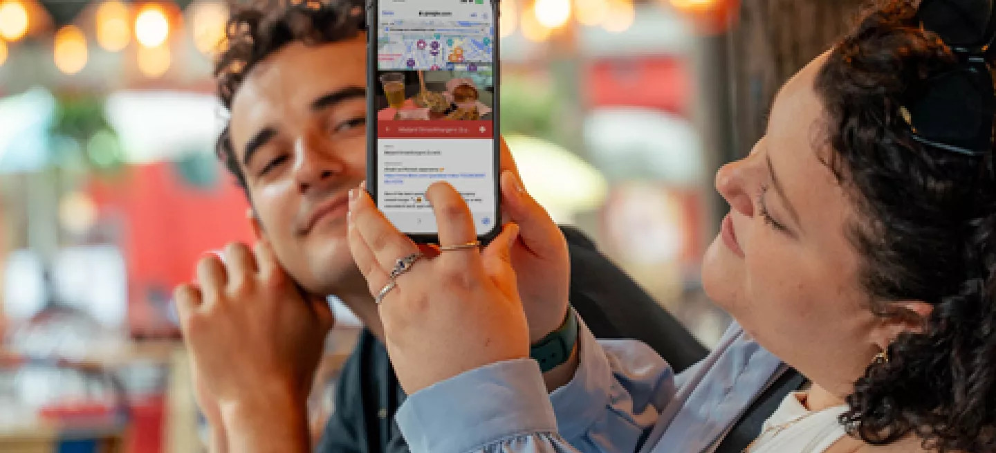 A person showing the Topdeck app on their phone.