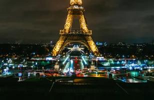 A view of Paris's famous Eiffel Tower lit up at night.