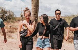 Group standing in the Arizona desert in front of a cactus.