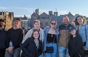 A group of Topdeck travellers posing for a photo together in Amsterdam.