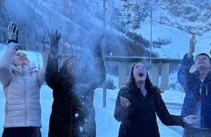 Topdeck group playing around and throwing snow in the air during a trip through the Swiss Alps.