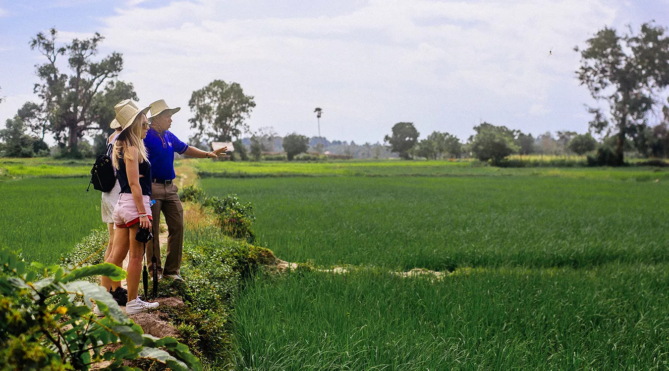 Two women on a tour of a rice field in Vietnam