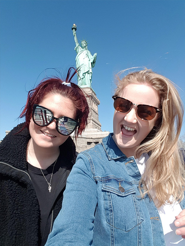 Topdeckers in front of the Statue of Liberty.