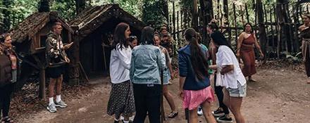 Topdeck tour group interacting with a tribal village.