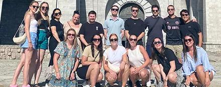 Topdeck group posing for a group photo in front of a cathedral.