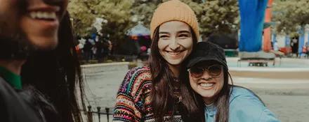 Topdeck travellers posing for a photo together in the park.